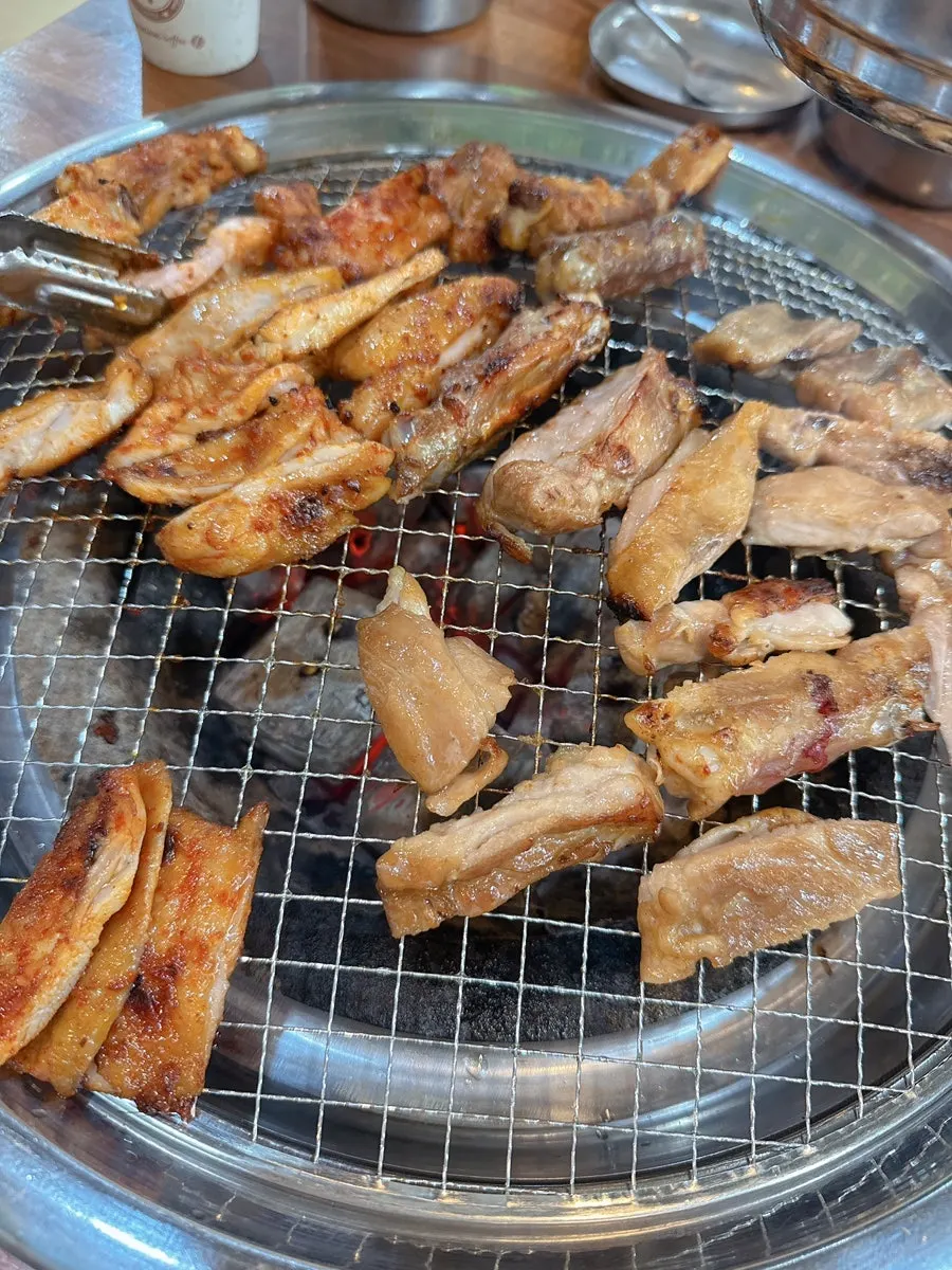 Table setting of charcoal dakgalbi with a bowl of rice