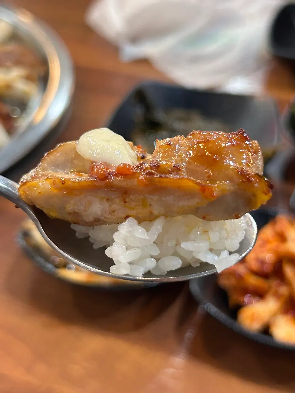 Dakgalbi wrap with rice and garlic on lettuce