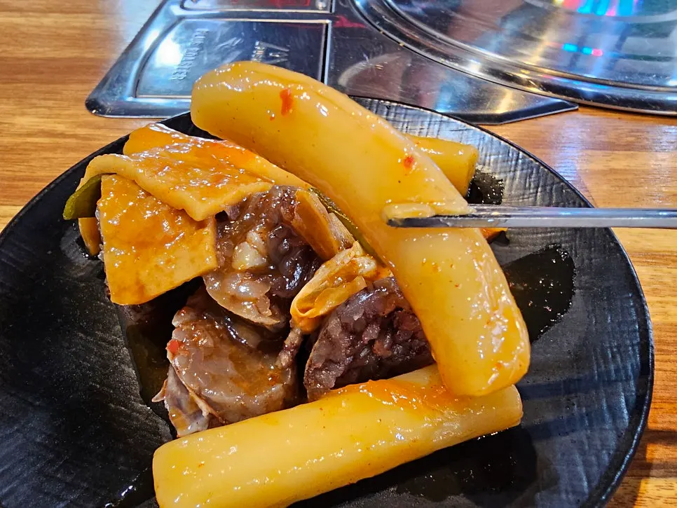 Plate of tteokbokki and snack food from the self-serve bar