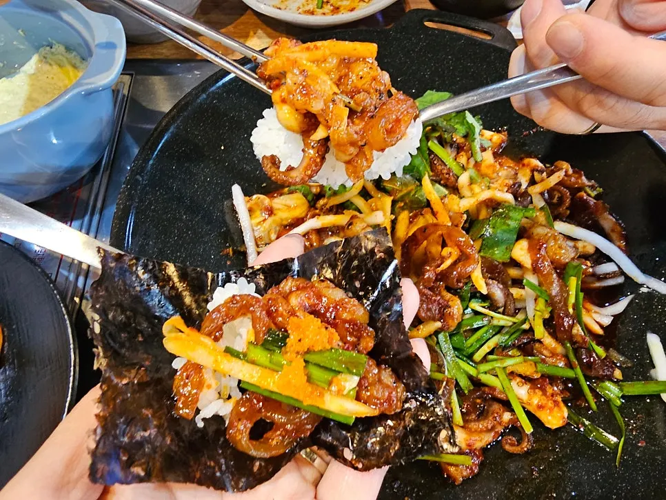 Full table spread with the octopus griddle, mukbap, and snack food