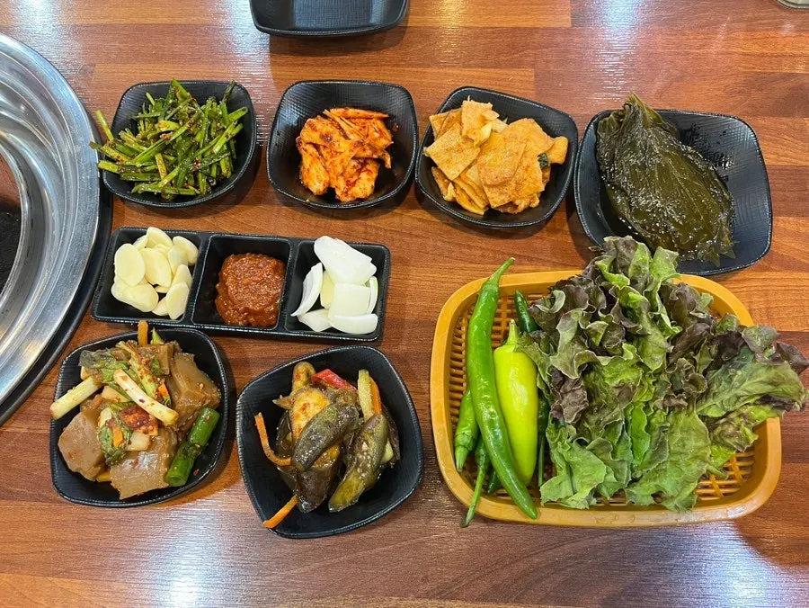 Full spread of banchan set on the table
