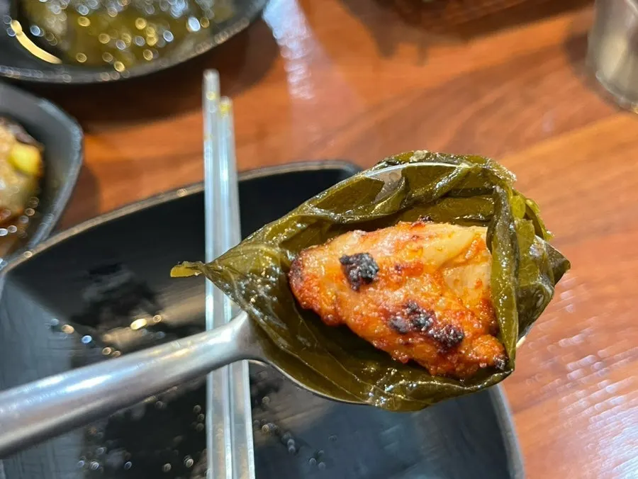 Seasoned dakgalbi wrapped in pickled perilla leaves