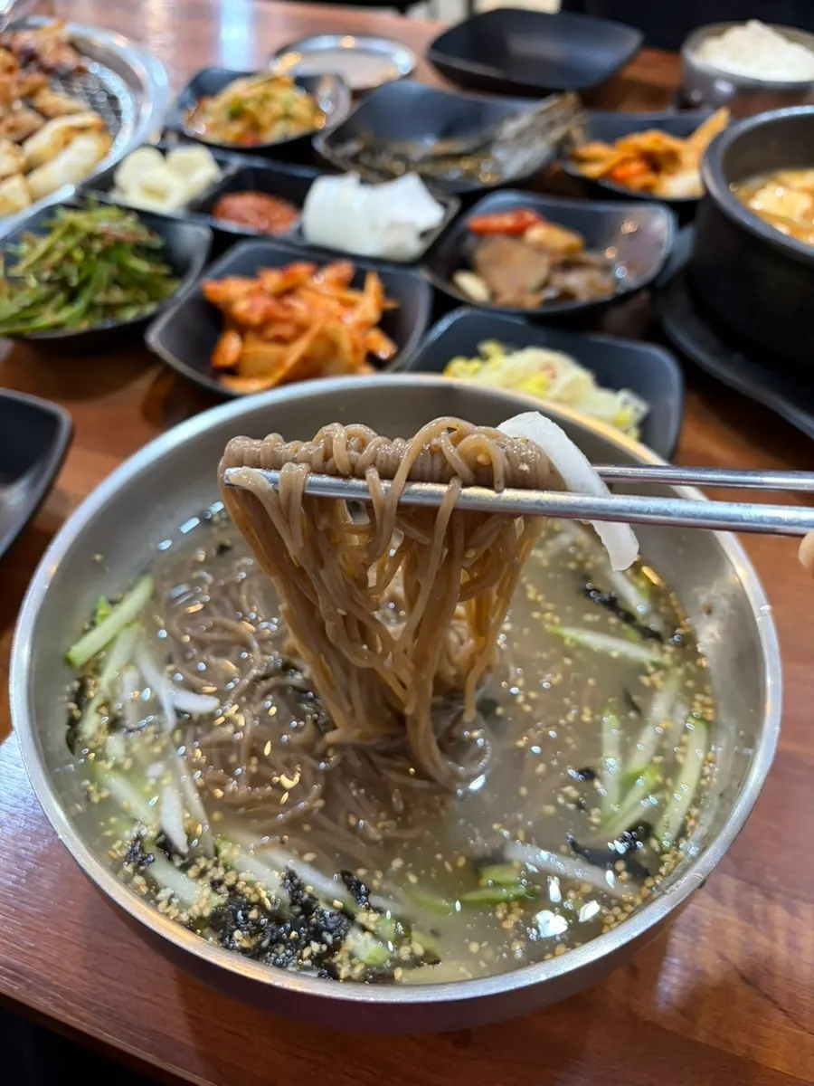 Half-and-half dakgalbi cooking over charcoal