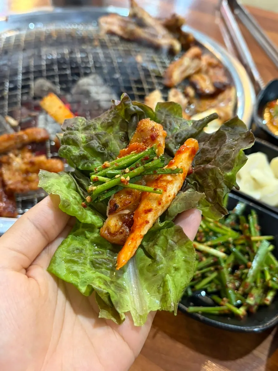 Dakgalbi topped with deodeok and chive salad