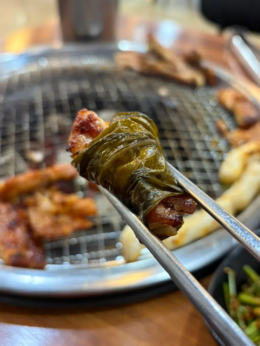 Charcoal dakgalbi wrapped in a perilla leaf