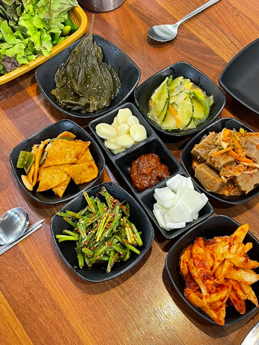 Basic table setting with deodeok muchim and chive salad