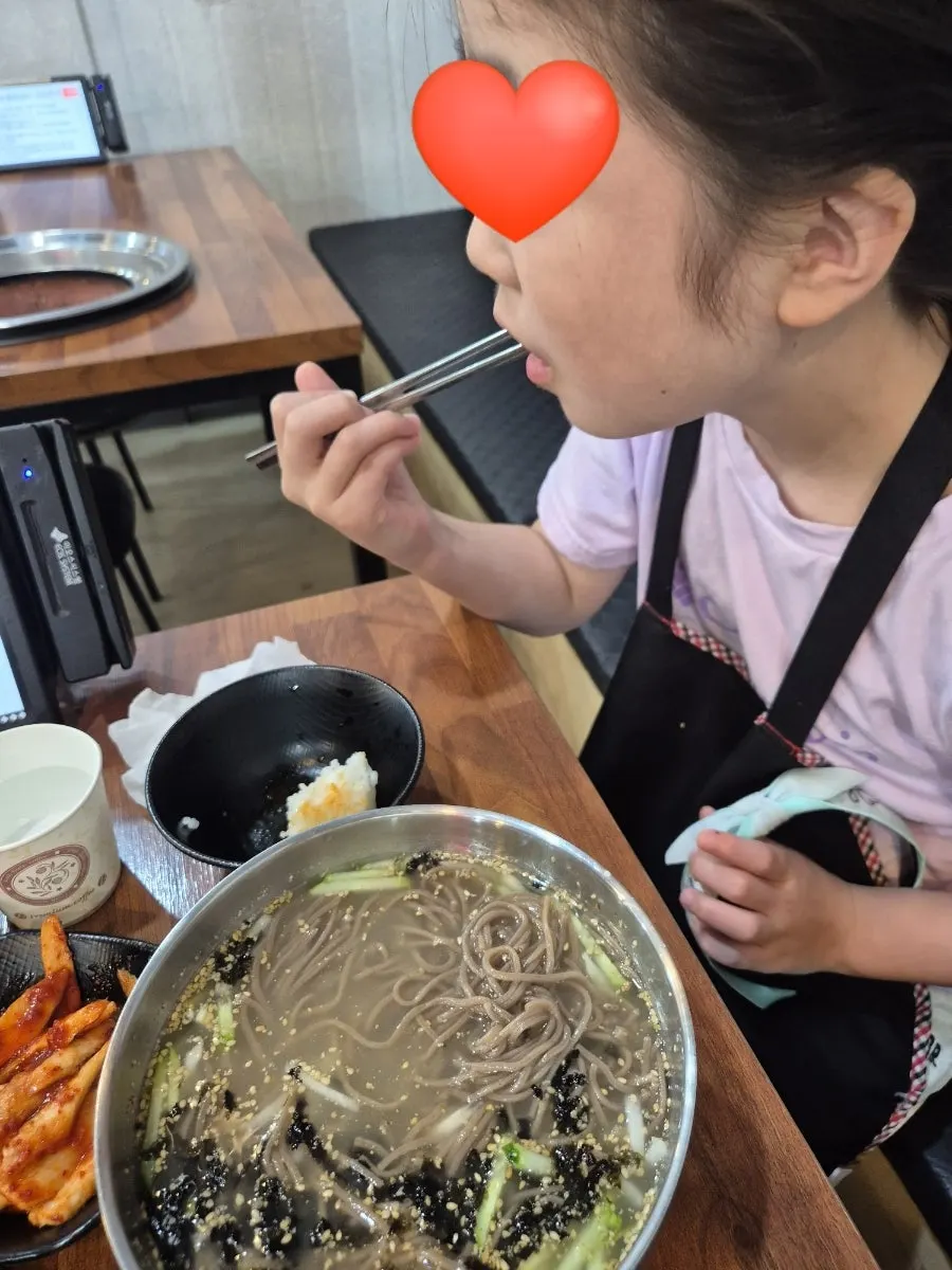 Sharing the gamjajeon around the table