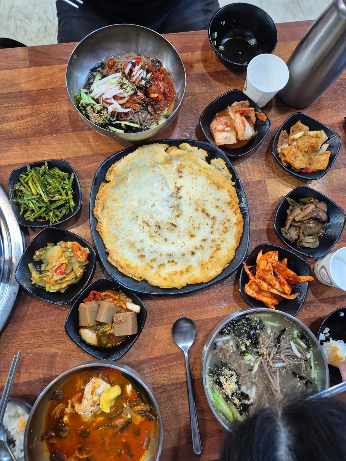 A piece of gamjajeon topped with chive kimchi