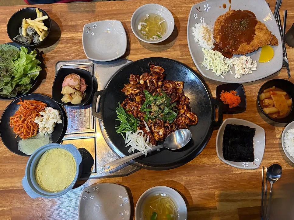 Full table spread of the grilled octopus and egg custard set