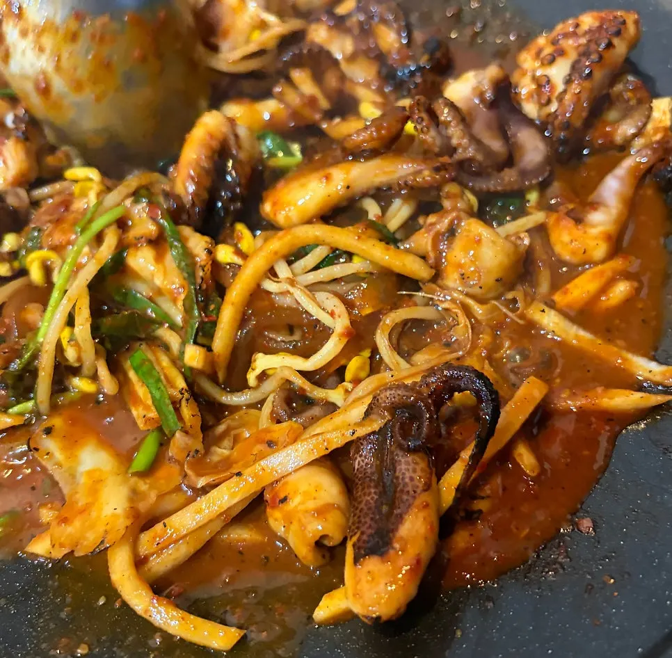 Grilled fire octopus simmering on the griddle