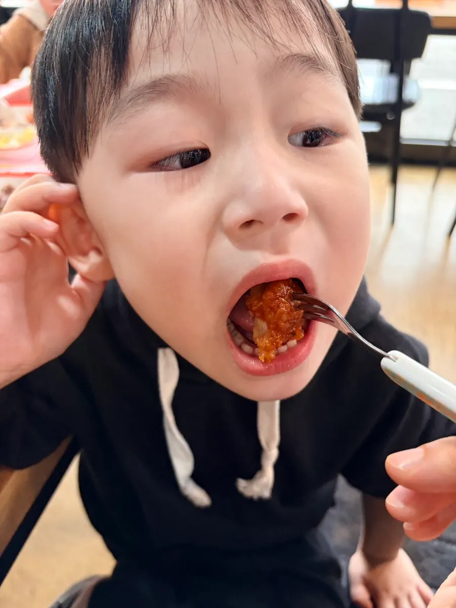 A child eating the pork cutlet
