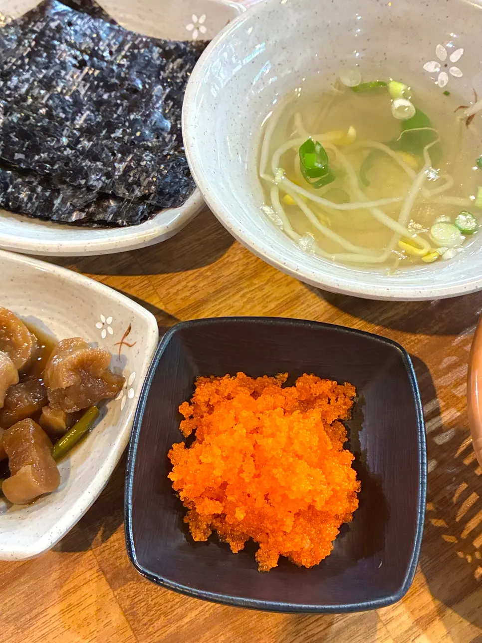 Standard table setting with bean sprout soup, flying fish roe, and seaweed
