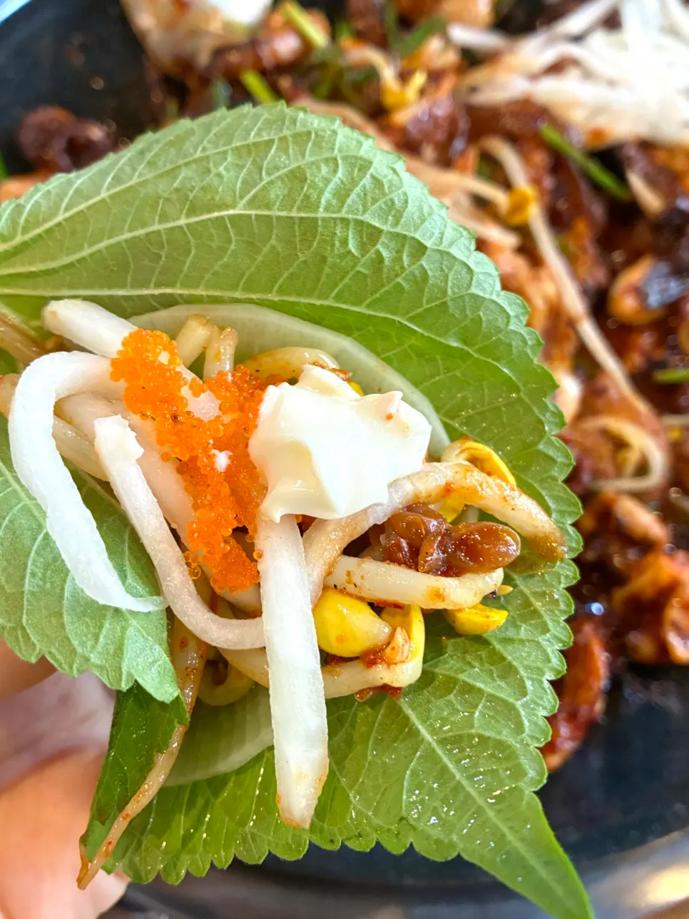 Jjukkumi topped with pickled radish and flying fish roe