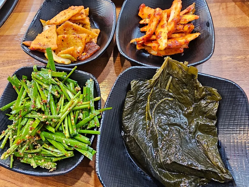 Banchan spread including deodeok-muchim and dotorimuk-muchim