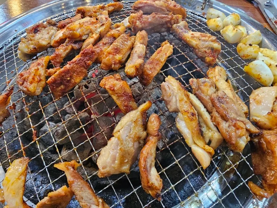 Table spread of dakgalbi and side dishes together
