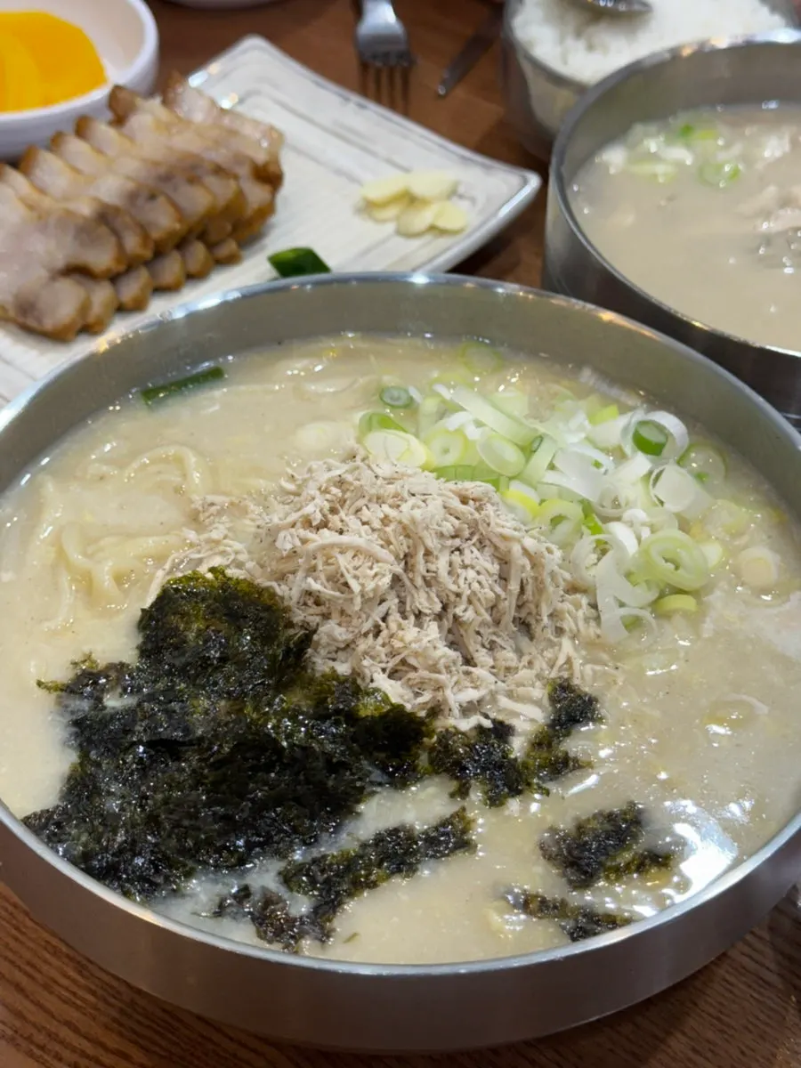 국물에 건져 올린 칼국수 면과 닭고기