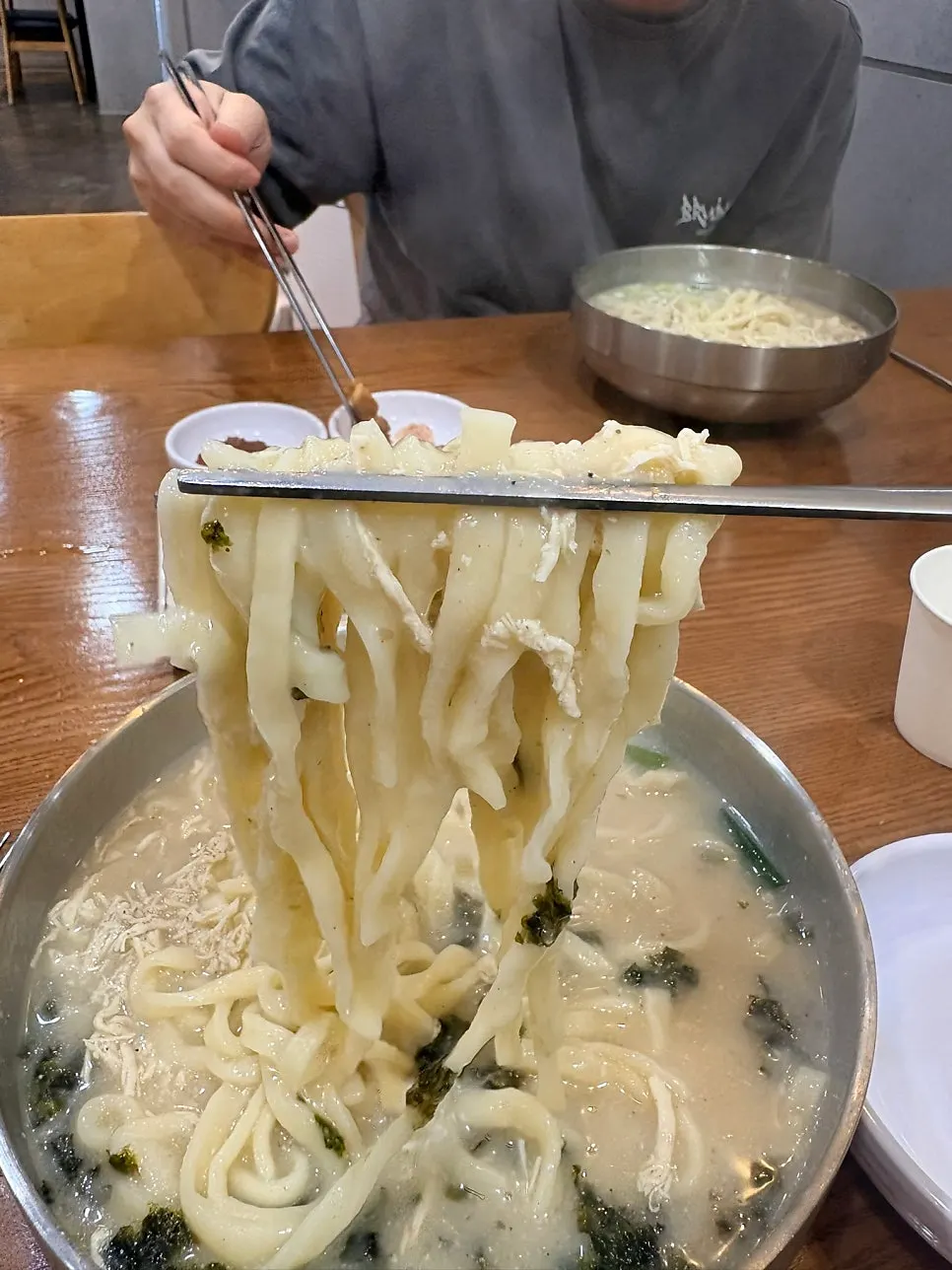 Chewy noodles lifted up from the bowl