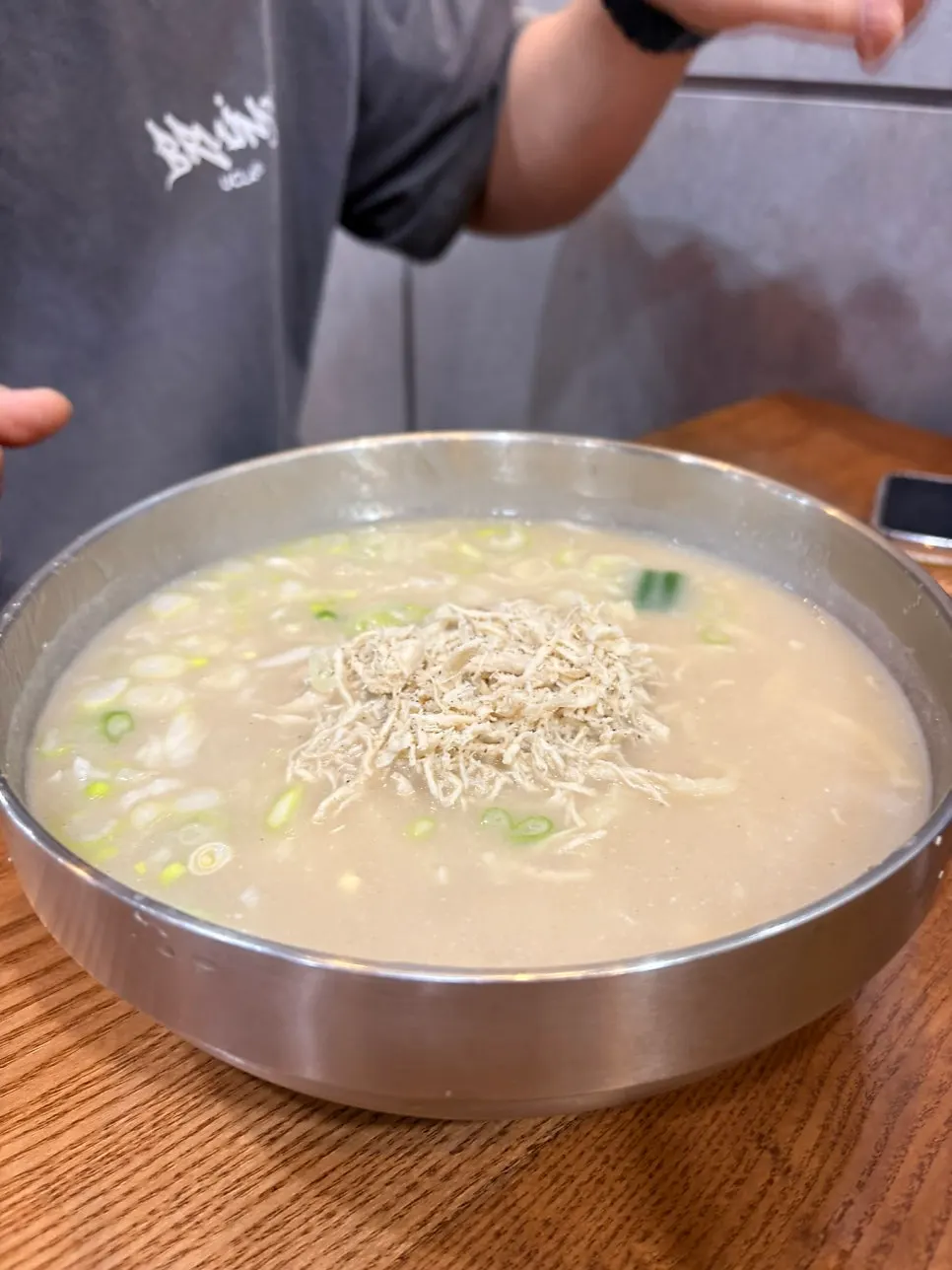 A bowl of chicken noodle soup with green onion topping