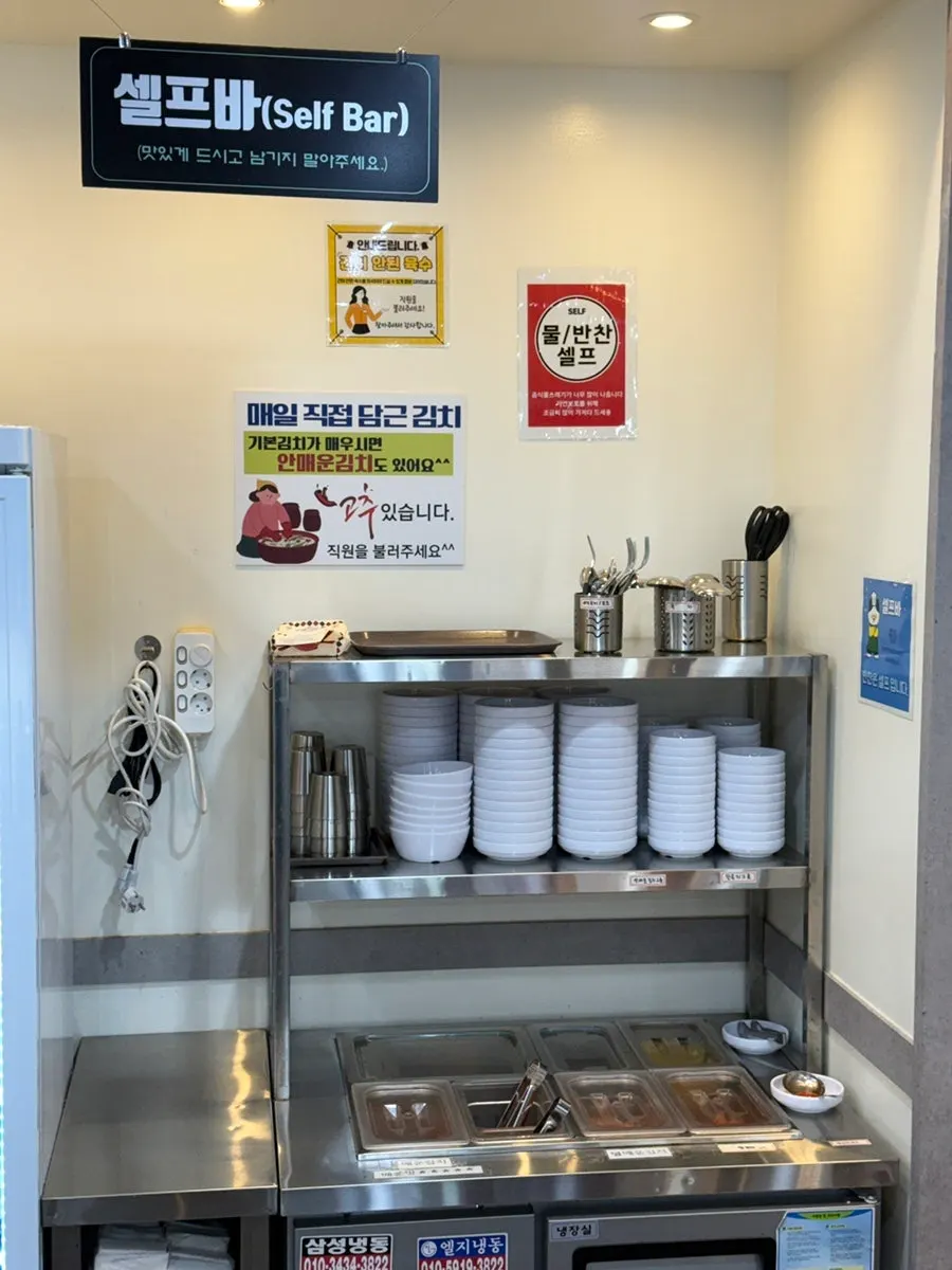 Wall with photos of hand-pulled kalguksu noodles being made