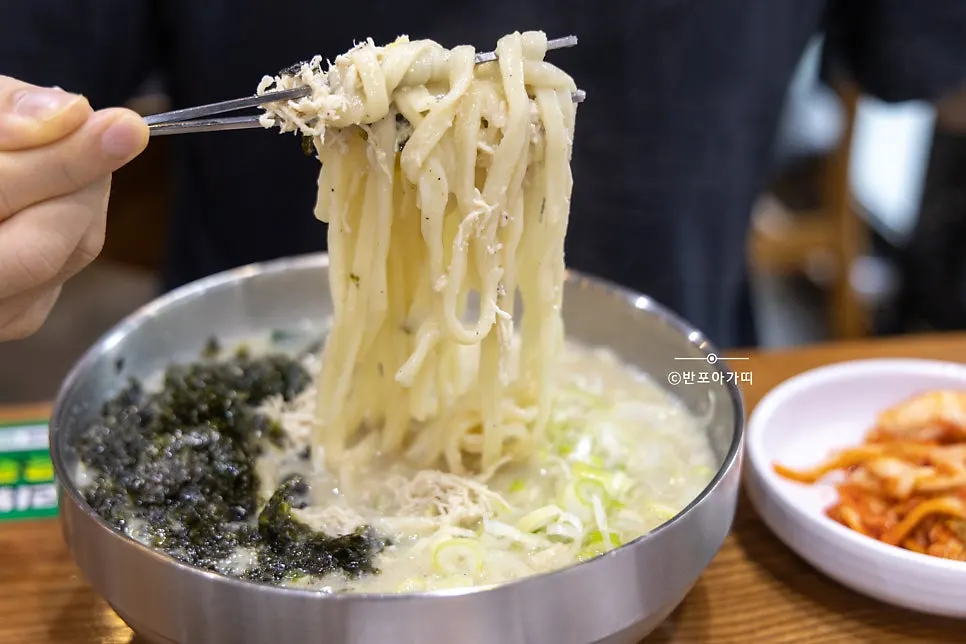 Dak kalguksu topped with egg and seaweed