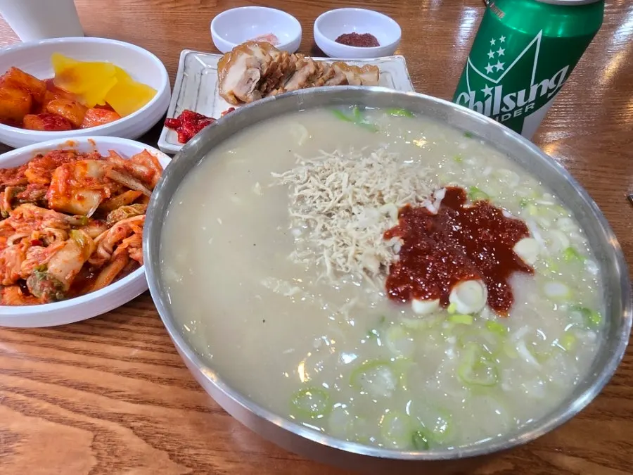 A bowl of kalguksu piled high with scallion topping