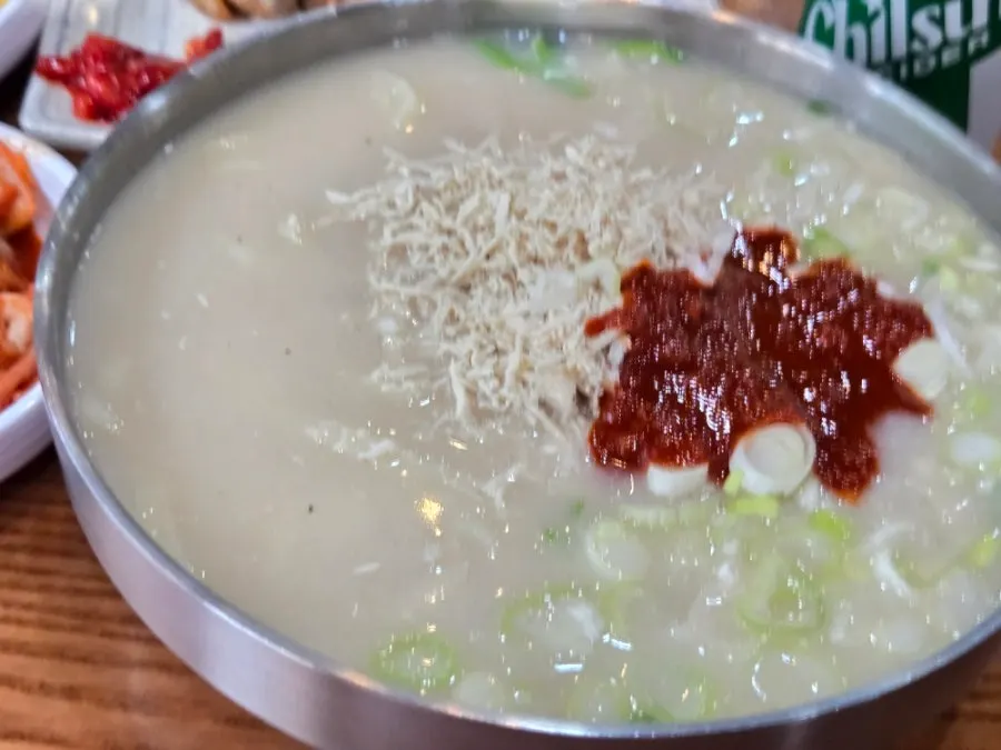 Table set with spicy chicken kalguksu and side dishes