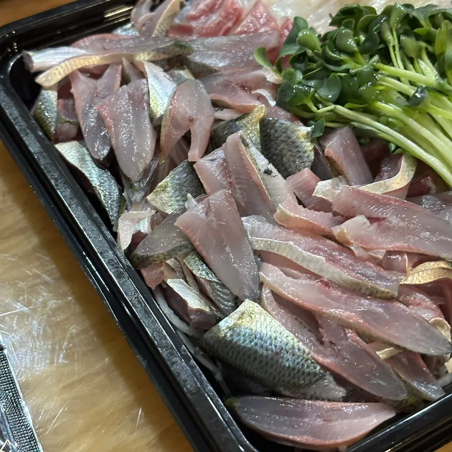 A piece of gizzard shad sashimi