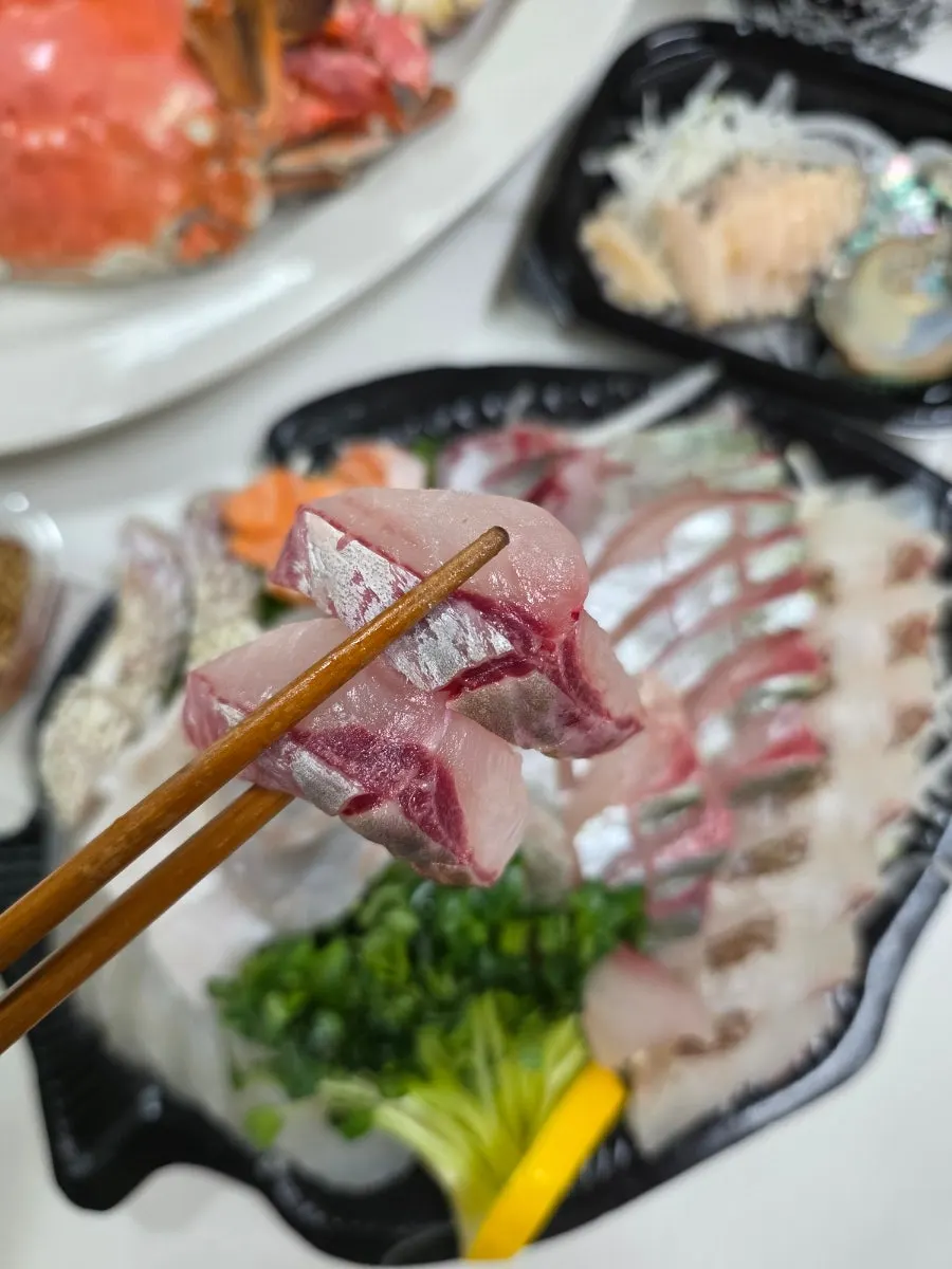A piece of fatty yellowtail scad sashimi