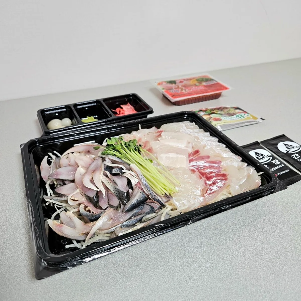 Mixed gizzard shad sashimi packed to go from Yeongjae Susan at Garak Market