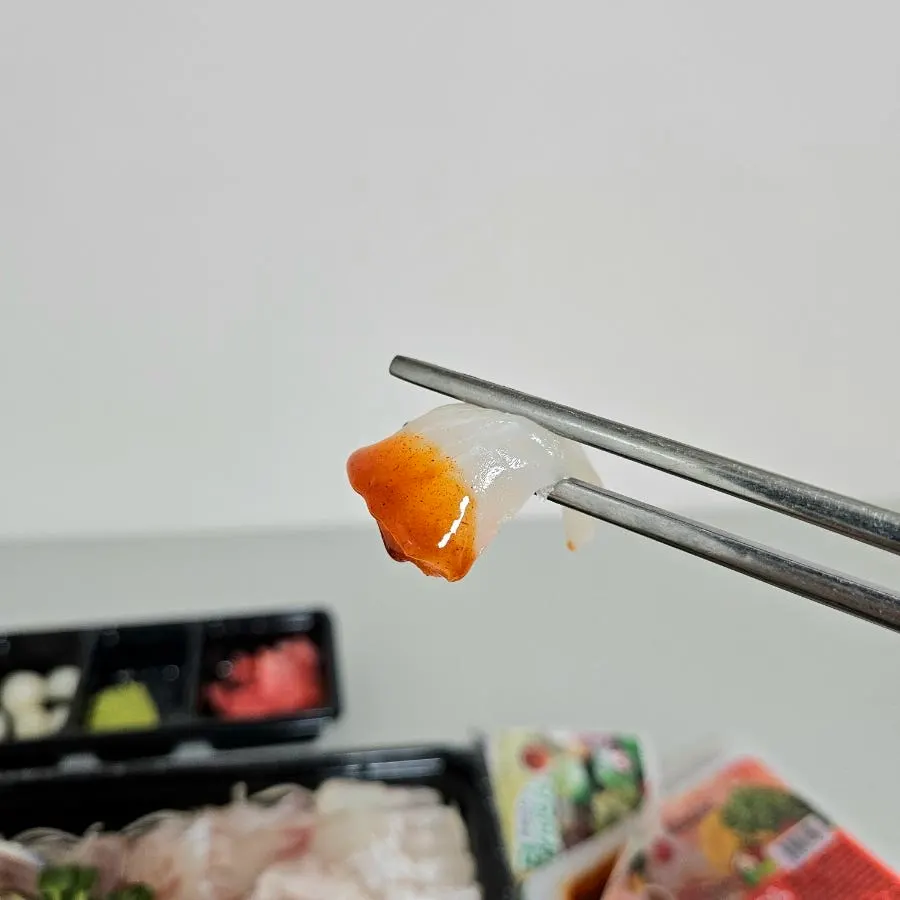 Sashimi dipped in wasabi and chogochujang