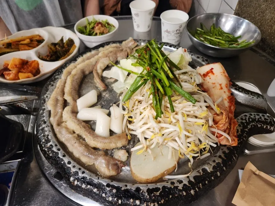 Two servings of beef gopchang served with vegetables