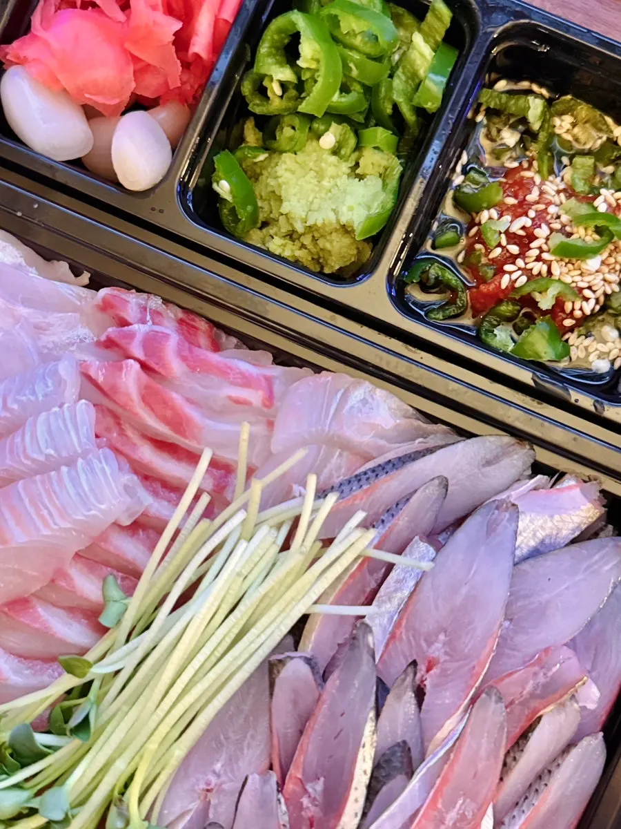 Generous layers of sashimi stacked underneath