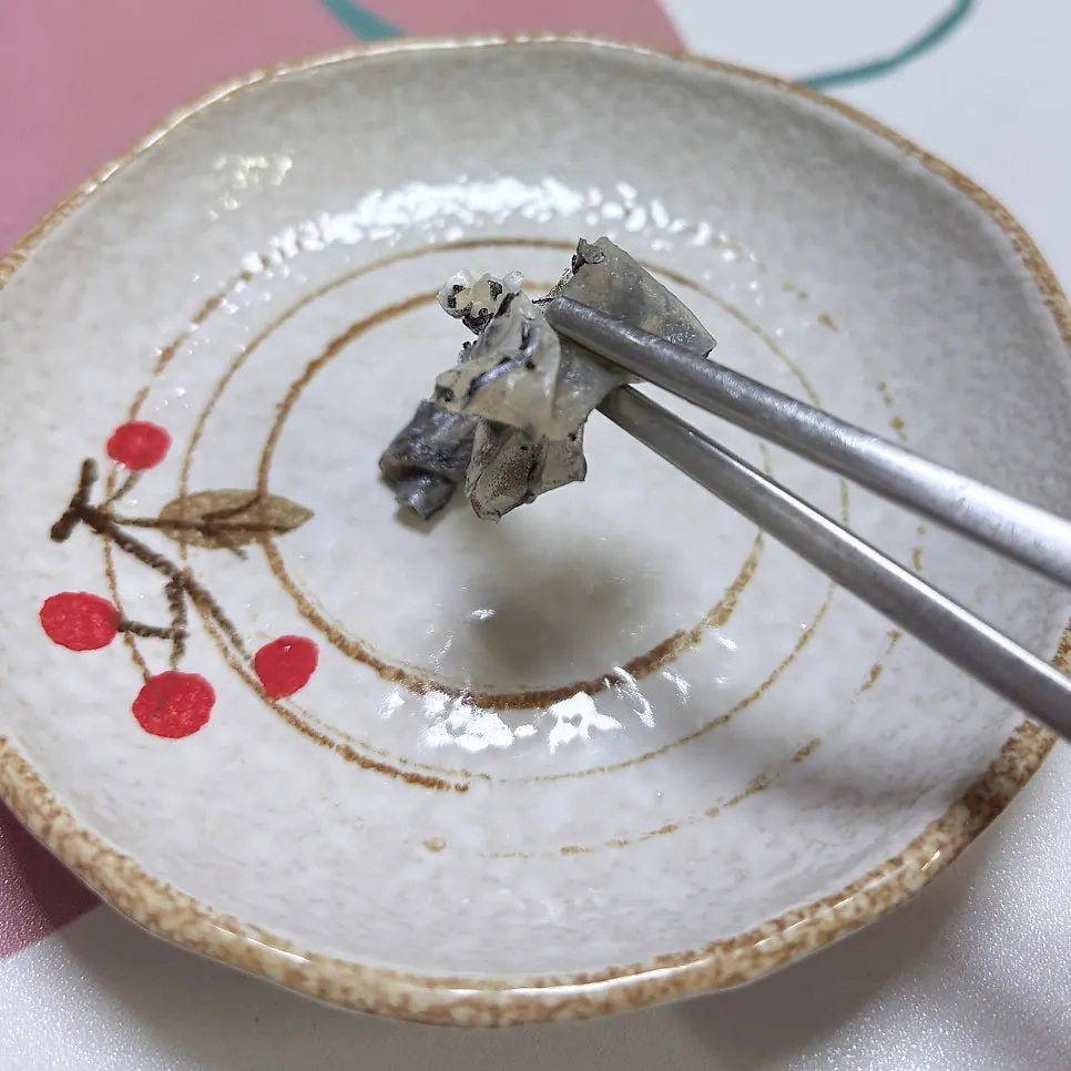 A piece of sashimi dipped in ssamjang