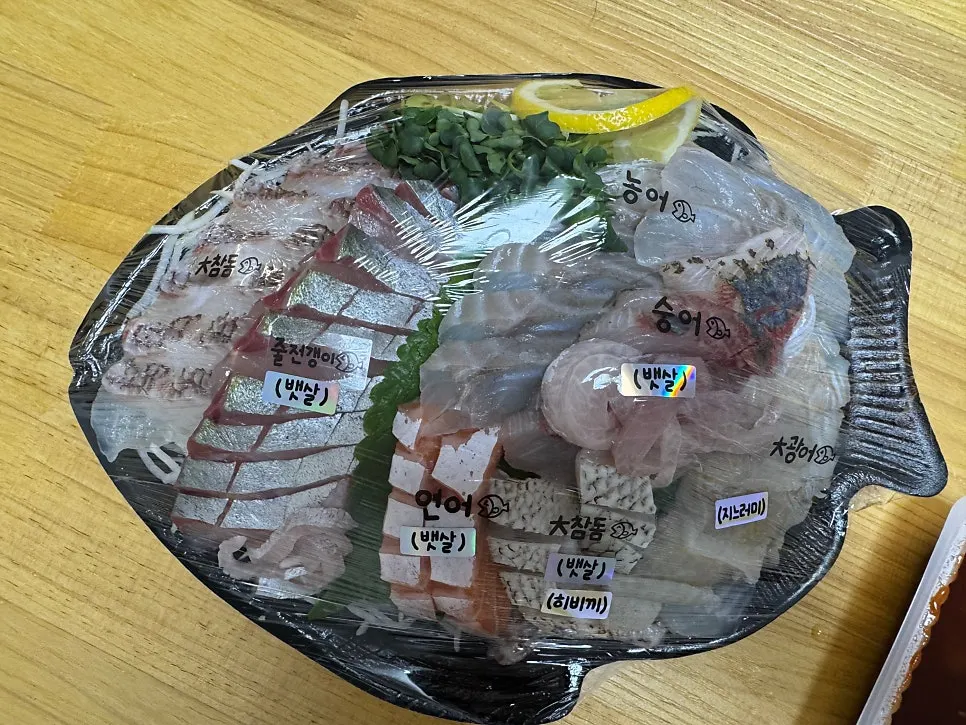 Assorted sashimi table spread packed to go from Garak Market