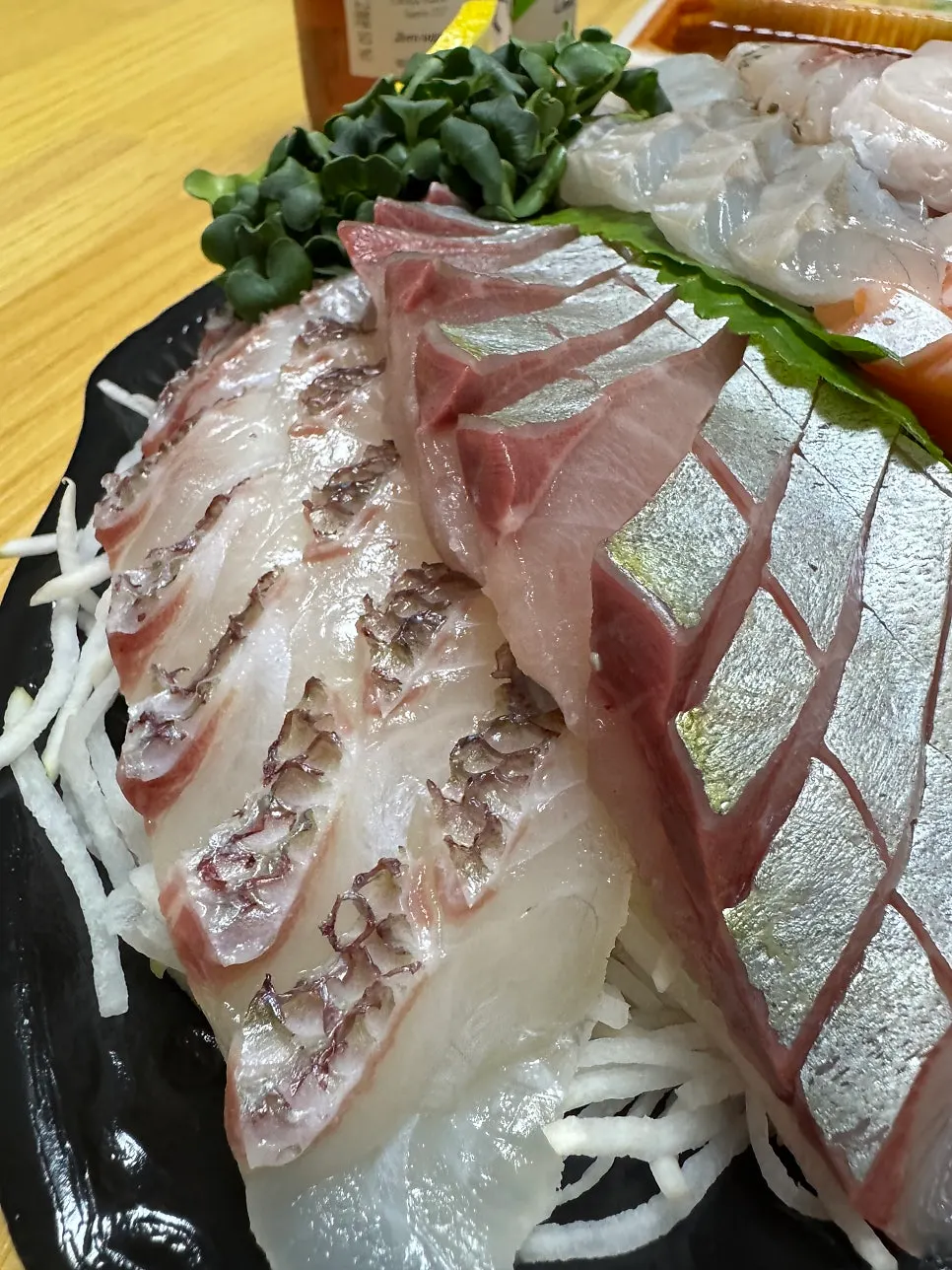 Assorted sashimi plate topped with striped jack and red seabream