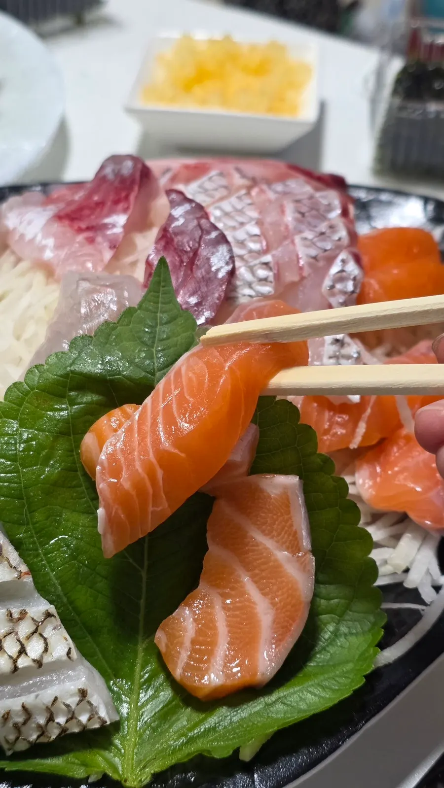 A thick-cut piece of live fish sashimi