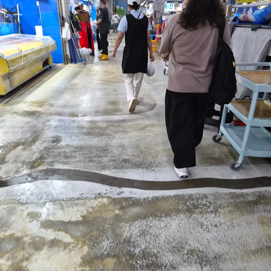 Walking through the Gaklak Mall corridor following restaurant staff