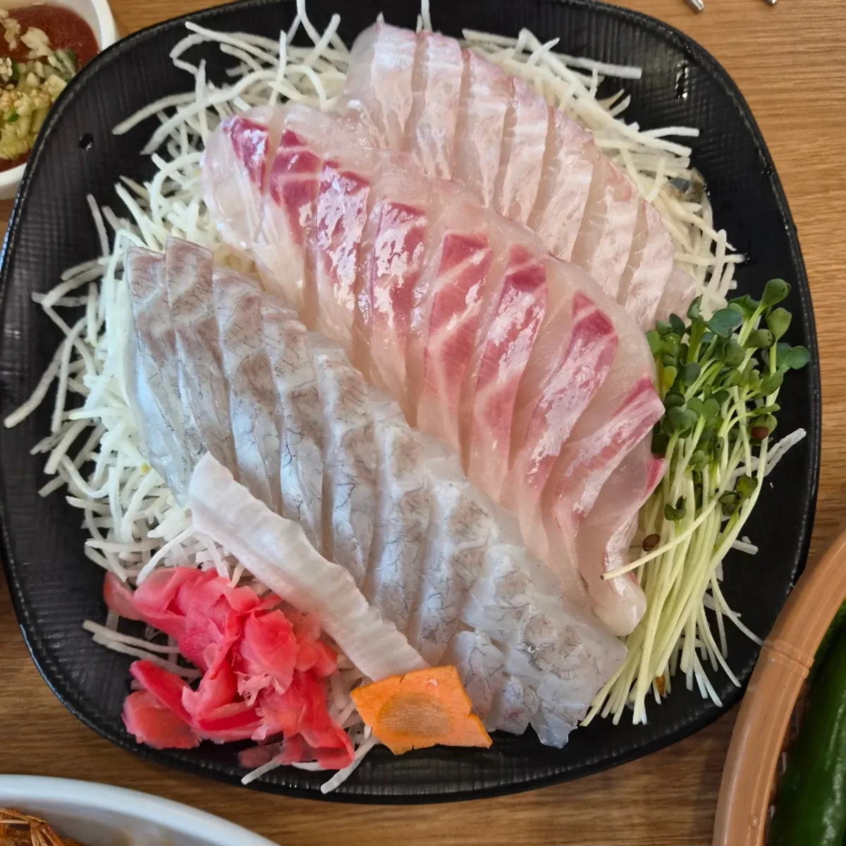 A neatly plated sea bream sashimi mini set