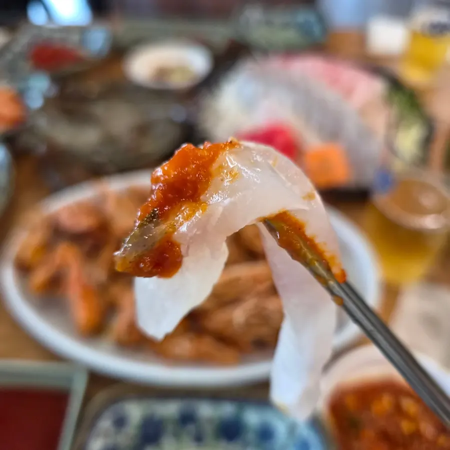 A bite combining sashimi and shrimp together