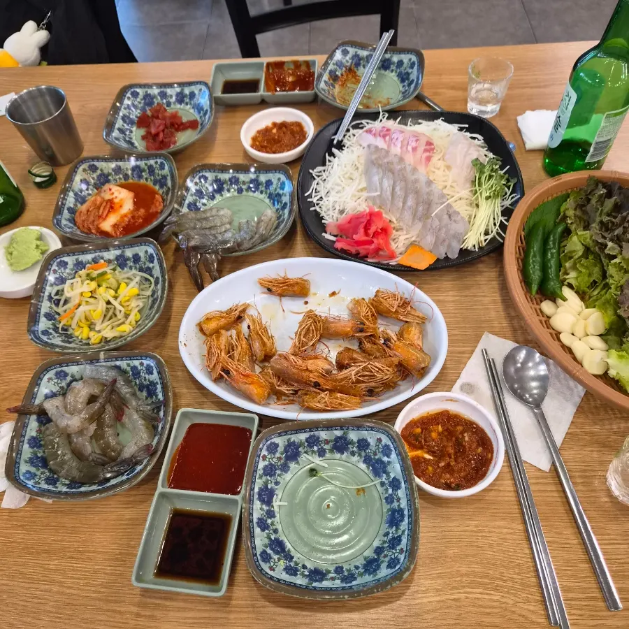 Sashimi dipped in wasabi soy sauce and ssamjang