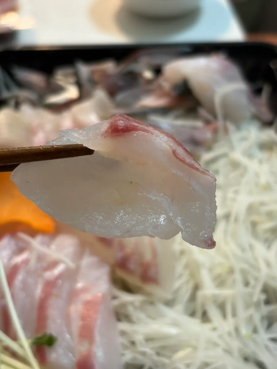 Home table spread of sashimi and live shrimp