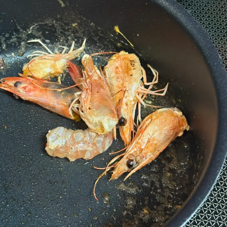 Frying shrimp heads in French butter