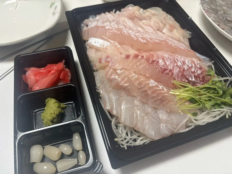 Standard side sauces including ginger, pickled radish, and wasabi