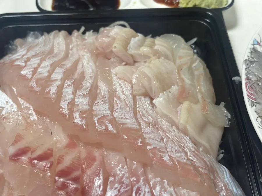 Picking up a long slice of sashimi
