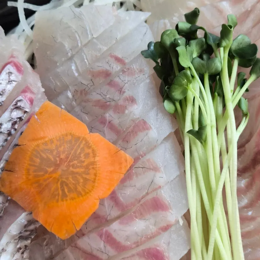 Gizzard shad sashimi with wasabi on soy sauce