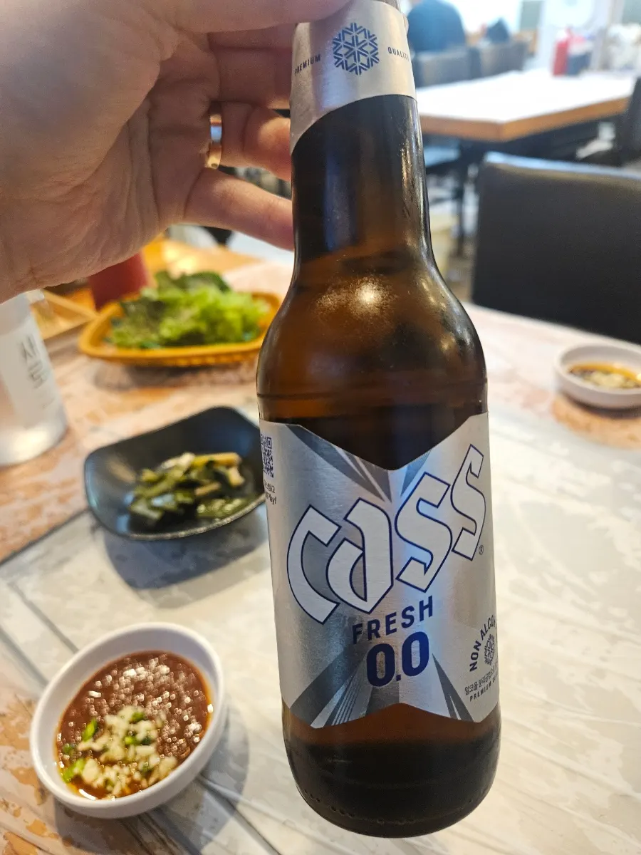 Non-alcoholic beer served alongside the table setting
