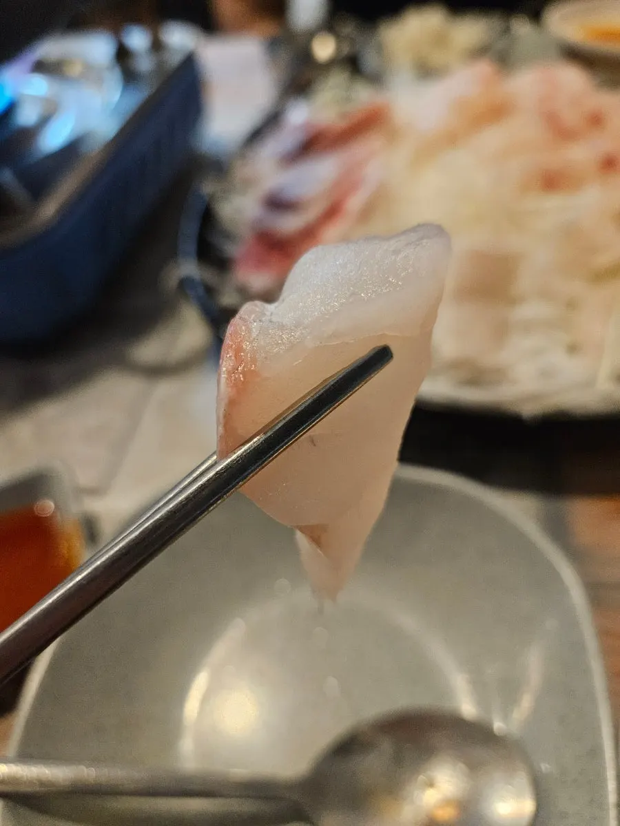 Picking up a thick piece of sashimi