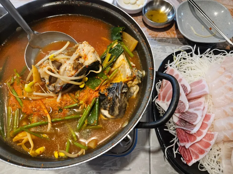 A pot of fish stew included in the table setting