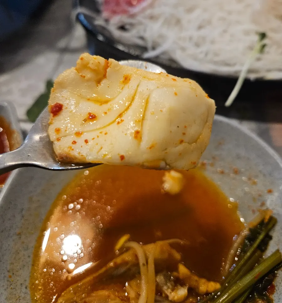 Sashimi lightly cooked shabu-shabu style in the fish stew broth