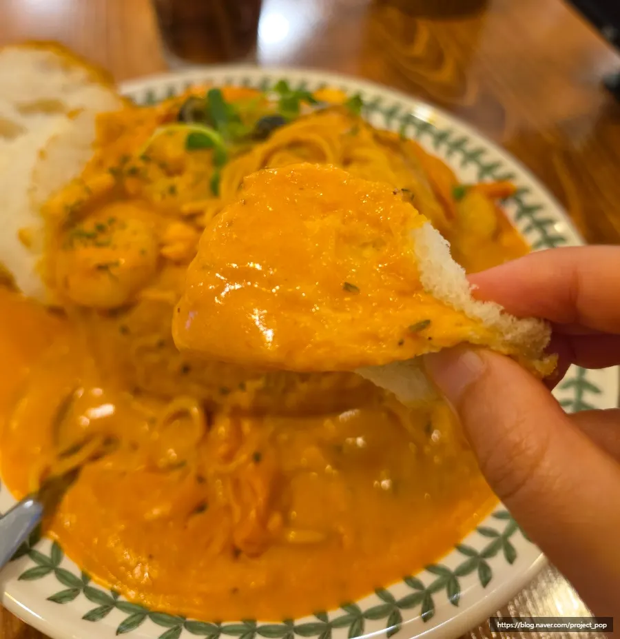 A piece of pane bread soaked in rosé sauce
